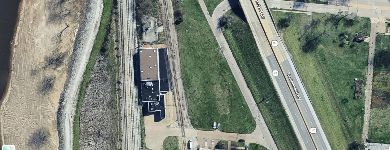 Aerial view showing building footprint with Route 92 frontage, rail line, and Mississippi River