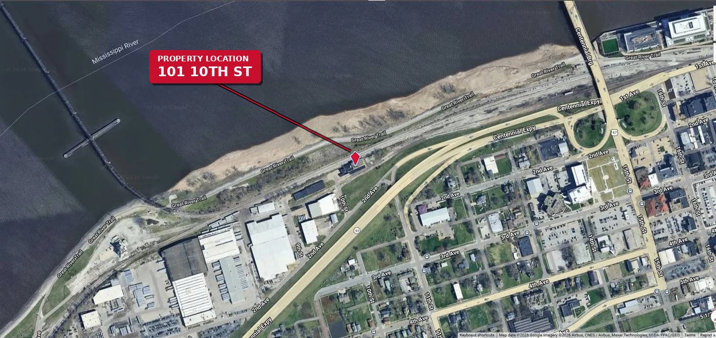 Close aerial view of 101 10th Street showing Mississippi River, rail line, and Centennial Expressway