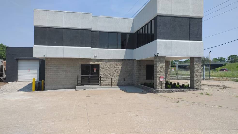 Front exterior showing office entrance, ADA ramp, and loading dock